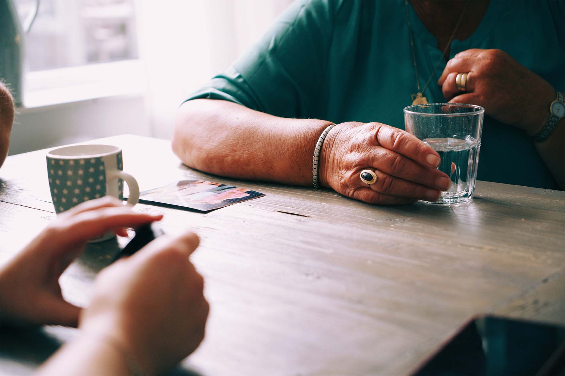 Residents playing a game of cards with a cup of tea