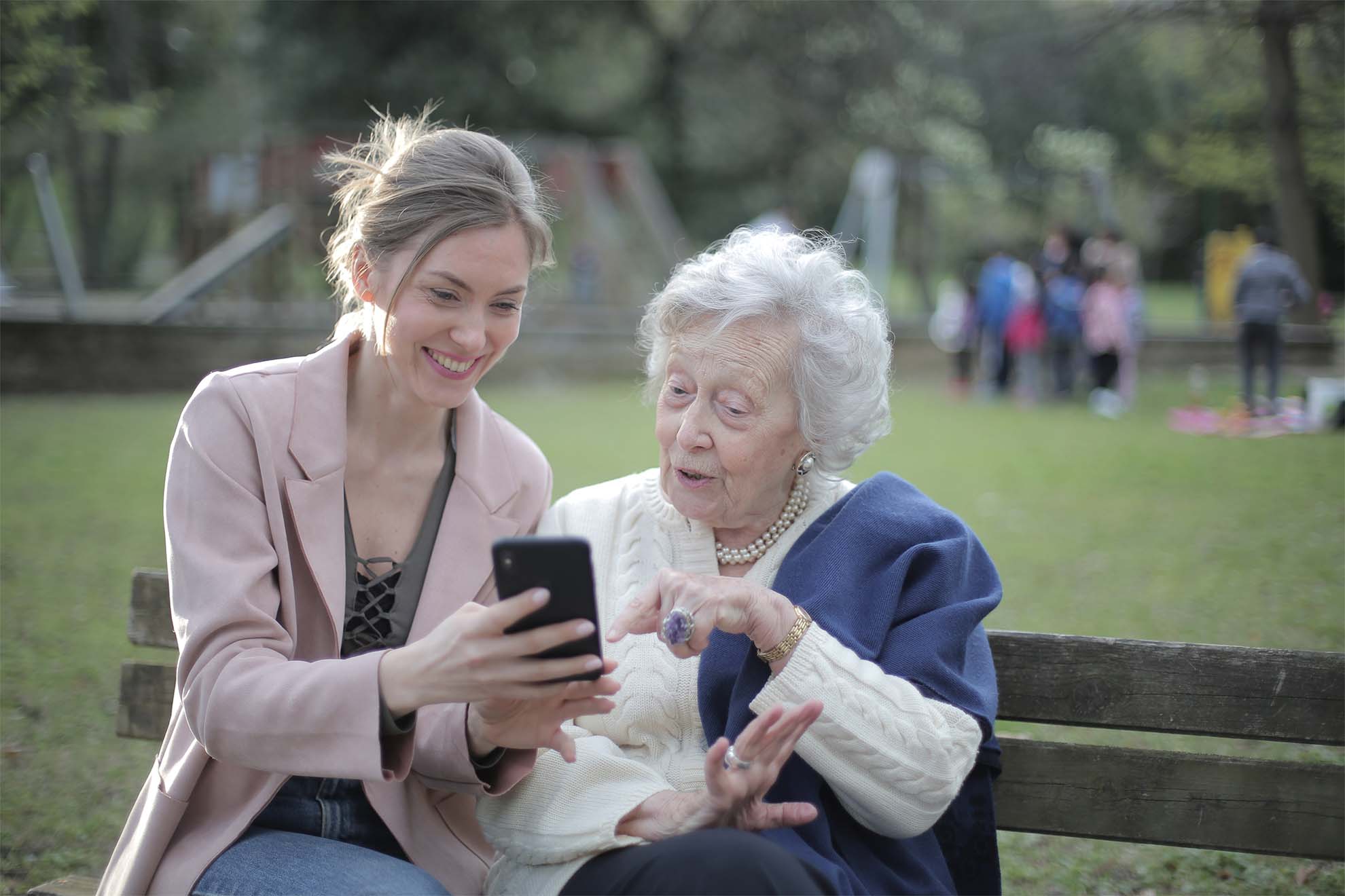 Resident and loved one looking at a mobile phone