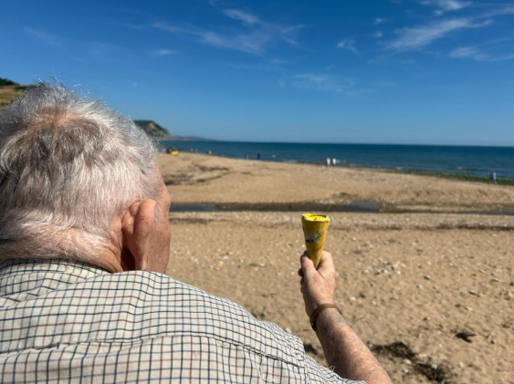 Resident enjoying an ice cream on the beach